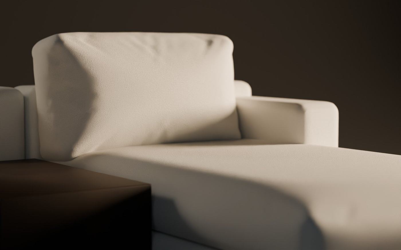 Close-up of a deep, soft cushion in ivory bouclé in low evening light